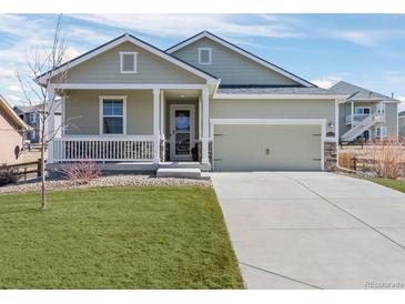Charming single-Gathering home with a well-manicured lawn and a welcoming covered front porch at 42338 Forest Oaks Dr, Elizabeth, CO 80107