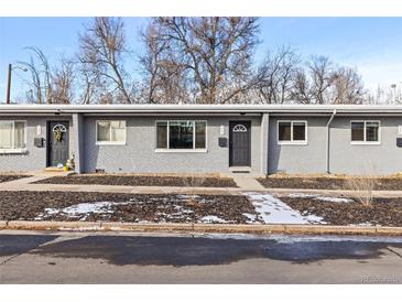 Charming multi-unit gray brick building with neat landscaping and walkway to the front doors at 2405 W 39Th Ave, Denver, CO 80211