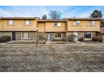 Charming townhouse with a well-maintained lawn and a cozy, inviting facade at 1191 S Troy St, Aurora, CO 80012