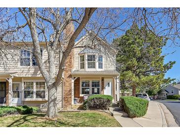 Charming townhouse featuring a well-maintained lawn and inviting entrance at 18273 E Arizona Ave # D, Aurora, CO 80017
