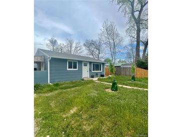 Cozy one-story home featuring a well-maintained lawn and a classic front door at 3101 W Jefferson Ave, Englewood, CO 80110