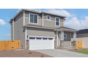 Charming two-story home featuring a two-car garage and neutral-toned siding at 17881 East 94Th Ave, Commerce City, CO 80022