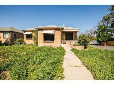 Charming brick home with a walkway, showing the potential for landscaping and curb appeal at 1195 Boston St, Aurora, CO 80010