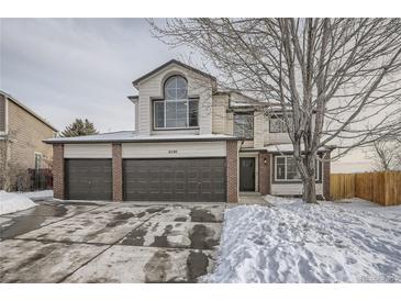 Charming two-story home with attached three-car garage and brick accents, perfect for a growing Gathering at 6550 S Oak Ct, Littleton, CO 80127