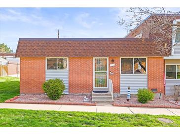 Charming brick home featuring a well-kept lawn and decorative front garden at 770 S Youngfield, Lakewood, CO 80228