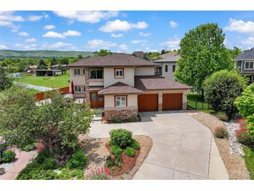 Beautiful two-story home featuring a 3-car garage, lush landscaping and scenic views at 913 Alkire Ct, Golden, CO 80401