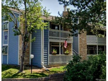 Charming condo exterior with stone accents, blue siding, and inviting front porch at 8600 E Alameda Ave # 17-203, Denver, CO 80247