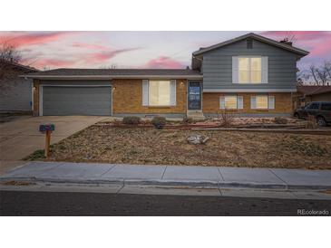 Charming split-level home with brick and siding exterior, attached garage, and a well-maintained front yard at 7074 Yates St, Westminster, CO 80030