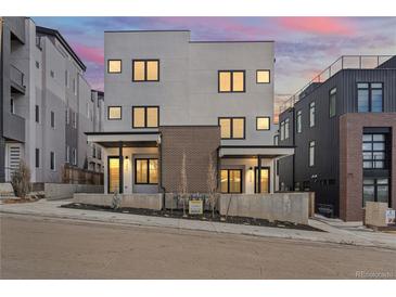 Modern two-story home featuring a neutral color palette, clean lines and stylish windows at 1256 Yates St, Denver, CO 80204