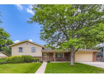 Charming single-Gathering home featuring mature trees, a well-maintained lawn, and a classic brick and siding exterior at 3724 S Poplar St, Denver, CO 80237