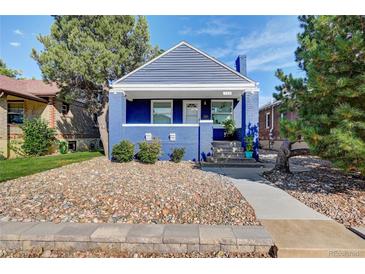 Charming blue brick home featuring a well-kept yard, blue gabled roof, and covered front porch at 706 S Lincoln St, Denver, CO 80209