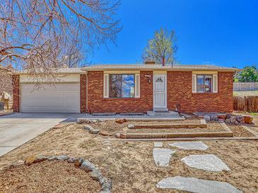 Charming brick home with a well-maintained front yard, inviting entrance, and attached two-car garage at 2675 S Carson Way, Aurora, CO 80014