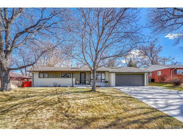 Charming single-story home with a well-maintained lawn and mature trees providing shade at 3680 S Glencoe St, Denver, CO 80237