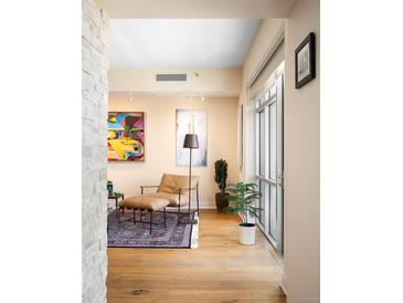 Inviting living room featuring stylish seating, hardwood floors, and large windows for ample natural light at 1411 Wynkoop St # 804, Denver, CO 80202