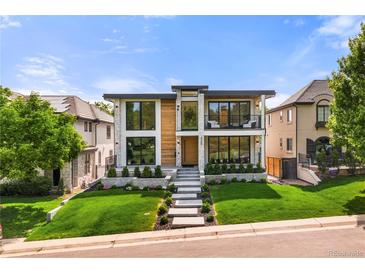 Stunning modern home featuring a manicured lawn and eye-catching architectural design at 220 Glencoe St, Denver, CO 80220