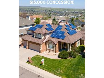 Inviting two-story home featuring a well-maintained lawn and solar panels at 58 Rogers Ct, Golden, CO 80401