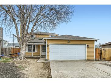 Charming two-story home with a two-car garage and a mature tree in the front yard at 1946 Ensenada St, Aurora, CO 80011