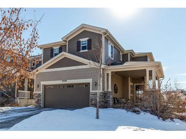 Two-story house with a brown exterior, large windows, and a covered porch at 23760 Eagle Bend Ln, Parker, CO 80138