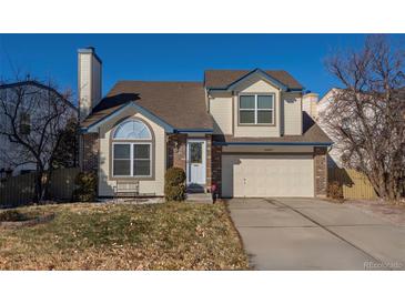 Charming two-story home featuring a well-maintained yard and attached two-car garage at 10407 Strasburg Way, Parker, CO 80134