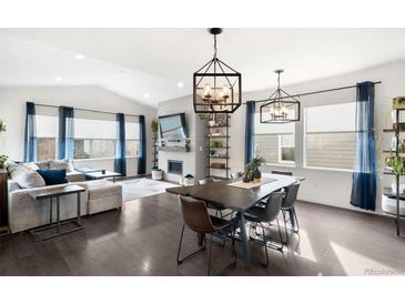 Spacious living room featuring a cozy fireplace and ample natural light at 9392 Anvil St, Arvada, CO 80007