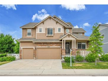 Beautiful two-story home featuring a stone and wood exterior with a large driveway and attached two-car garage at 20145 E Fair Ln, Centennial, CO 80016