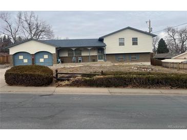 Ranch style home with attached two-car garage and landscaped yard at 13389 W Ohio Ave, Lakewood, CO 80228