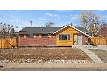 Lovely single Gathering home featuring brick and wood siding, and freshly laid mulch in the front yard at 2415 E Maplewood Ave, Centennial, CO 80121