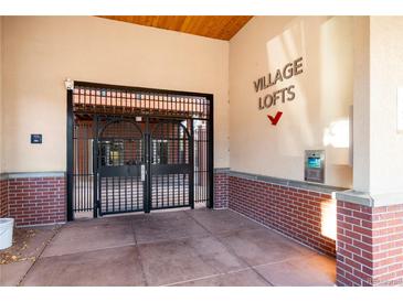 Secured entrance to Village Lofts features brick accents and gated access for added safety and peace of mind at 5677 S Park Pl # C208, Englewood, CO 80111