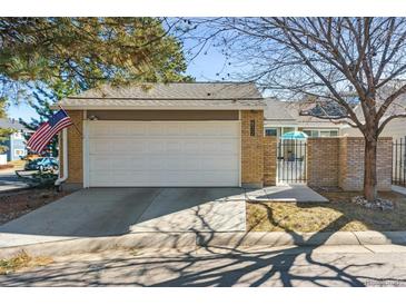 Charming single Gathering home featuring a two-car garage and flag at 7255 S Vine St, Centennial, CO 80122