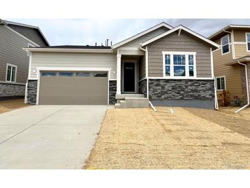 Charming single-Gathering home with a two-car garage and stone accents at 24747 E 40Th Ave, Aurora, CO 80019