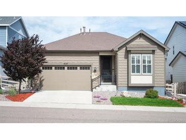 Charming single-story home featuring an attached two-car garage and low maintenance front yard at 9157 Rio Lado St, Littleton, CO 80125