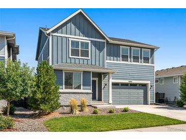 Charming two-story home with blue siding, gray accents, a well-maintained lawn and low maintenance landscaping at 26857 E Maple Ave, Aurora, CO 80018