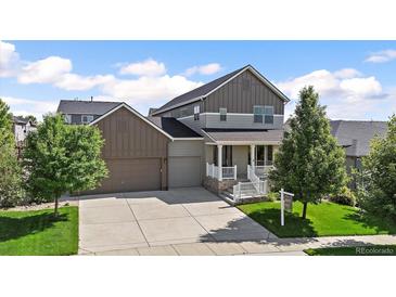 Charming two-story home with two-car garage and welcoming front porch at 4565 Colorado River Dr, Firestone, CO 80504