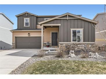 Exterior view of a home featuring a two-car garage and a well maintained front yard at 4807 River Highlands Loop, Elizabeth, CO 80107