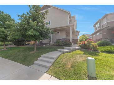 Inviting two-story home featuring a well-maintained lawn and concrete steps leading to the front door at 18096 E 104Th Way, Commerce City, CO 80022