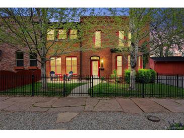 Charming brick home with black fence, red accents, small front yard, and mature trees at 1717 E 22Nd Ave, Denver, CO 80205