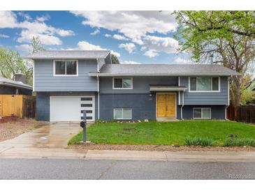 Charming two-story home with a well-manicured front yard and a two car garage at 8506 Eaton St, Arvada, CO 80003