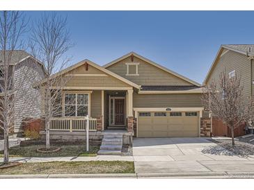 Charming single-Gathering home featuring a manicured front yard and an attached two-car garage at 14952 Vienna Cir, Parker, CO 80134