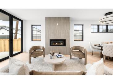 Cozy living room with fireplace, neutral tones, and lots of natural light at 1823 W 35Th Ave, Denver, CO 80211