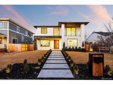 Contemporary two-story home boasts a sleek design and manicured front yard, enhancing curb appeal at 1518 S Columbine St, Denver, CO 80210