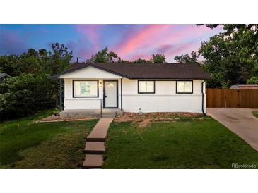 Charming single-story home boasts a well-manicured lawn and freshly painted exterior at 871 S Worchester St, Aurora, CO 80012