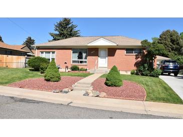 Charming brick home featuring manicured landscaping and a welcoming front entrance at 10759 Ogden St, Northglenn, CO 80233