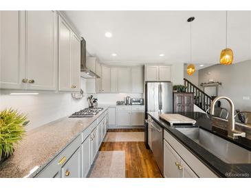 Modern kitchen boasts granite countertops, stainless steel appliances, and ample cabinet space at 8872 E 47Th Ave, Denver, CO 80238