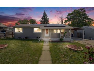 Charming single-story home with solar panels and well-maintained front yard at dusk at 7350 Dale Ct, Westminster, CO 80030