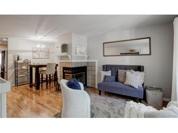 Cozy living room features a fireplace and built-in shelving at 1885 S Quebec Way # H15, Denver, CO 80231