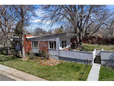 Stunning exterior view of home, with a modern design and mature trees, nestled in a quiet neighborhood at 1400 E Bates Ave, Englewood, CO 80113