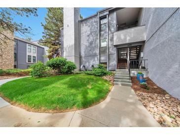 Inviting exterior with lush lawn and a walkway leading to the home's entrance and second story at 6410 S Dayton St # I05, Englewood, CO 80111