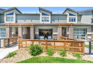 Charming townhouse featuring a cozy front patio and modern architectural details at 4021 S Teller St, Lakewood, CO 80235