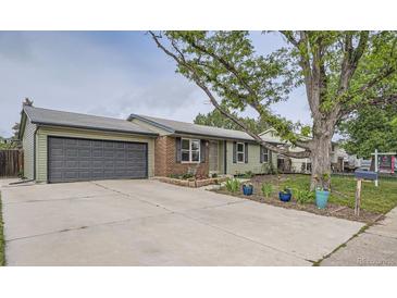 Charming single Gathering home with attached garage and landscaping in front yard at 5925 W 86Th Ave, Arvada, CO 80003