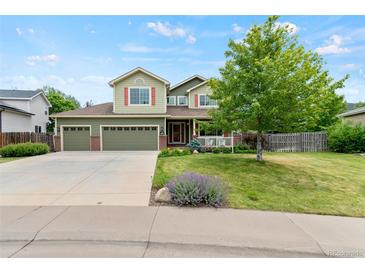 Charming two-story home featuring a three-car garage and a welcoming front porch at 5980 Dunraven Ct, Golden, CO 80403